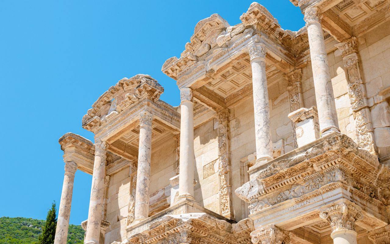 The upper storeys of the Library of Celsus at Ephesus against a clear blue sky.